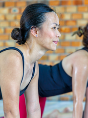 Middle aged woman doing yoga and enjoying pain-free flexibility. 
